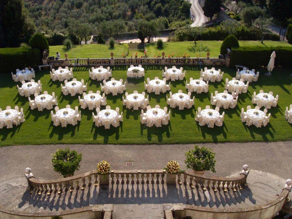 Setup of a wedding dinner in the garden of Tenuta di Artimino