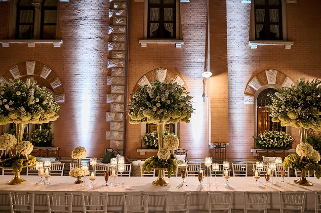 Table setting with flower arrangements from a wedding at Castello di Spessa